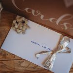 Envelope on table with gift decorations.