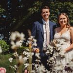 Smiling couple on wedding day in garden