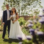 Bride and groom in garden, wedding day celebration