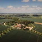 Aerial view of countryside estate and surrounding fields.