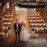 Bride and groom in rustic wedding venue.