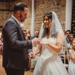 Couple exchanging rings at wedding ceremony.