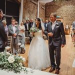 Bride walking down aisle at wedding ceremony