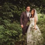 Bride and groom in lush green garden