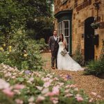 Bride and groom in garden wedding scene