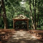 Outdoor wedding gazebo with benches and fairy lights