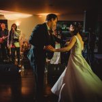 Couple dancing at a wedding reception with band.