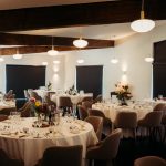 Elegant dining room with decorated tables and chairs.