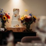 Three-tier wedding cake with colourful flowers