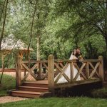 Bride and groom on wooden bridge in garden