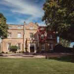 Historic manor house with lush gardens.