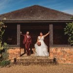 Bride and groom outside brick wedding venue