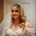 Bride in white dress and veil smiling