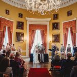 Elegant indoor wedding ceremony in historic room.