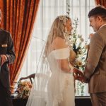 Bride and groom exchanging vows at wedding ceremony.