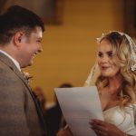 Bride and groom exchanging vows at wedding ceremony.