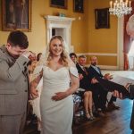 Bride and groom holding hands at wedding ceremony.