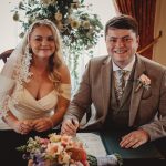 Bride and groom signing marriage certificate