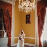 Bride in elegant room with chandelier.