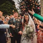 Bride and groom showered with confetti at wedding