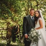 Bride and groom standing in a garden