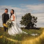 Bride and groom in sunny meadow