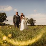 Bride and groom in a sunny field