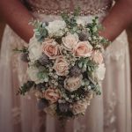 Bride holding a floral wedding bouquet.