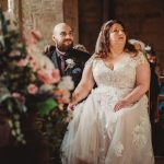 Bride and groom seated in a rustic ceremony.