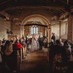 Wedding ceremony in historic stone chapel.