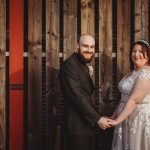 Smiling couple holding hands at wedding