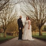 Bride and groom in countryside wedding scene