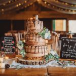 Rustic wedding cake with chocolate drip decoration.