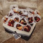 Basket of lace-wrapped rose petals on stone floor.