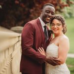 Smiling couple in wedding attire outdoors