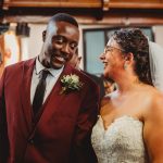 Smiling bride and groom at wedding ceremony.