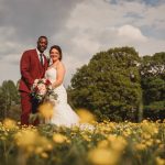 Wedding couple in field of yellow flowers