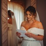 Bride reading letter before wedding ceremony