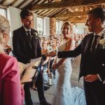 Wedding ceremony with couple and officiant indoors