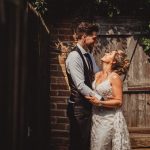 Happy couple embracing at rustic outdoor wedding