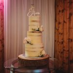 Three-tiered rustic wedding cake with flowers