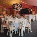 Elegant wedding reception with floral centrepieces.