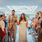 Wedding couple smiling during confetti celebration