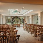 Elegant wedding ceremony room with floral arch