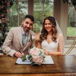 Bride and groom signing marriage certificate