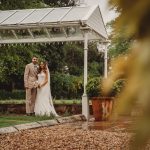 Bride and groom under outdoor shelter