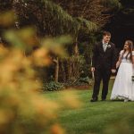 Bride and groom walking in a garden