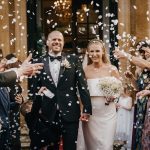 Bride and groom showered with confetti.