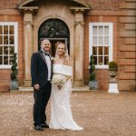 Bride and groom outside a historic building.