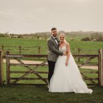 Bride and groom in countryside wedding scene